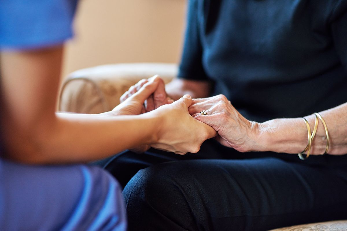 Nurse holding older woman's hands | Image credit: Cecilie Arcurs:peopleimages.com - stock.adobe.com