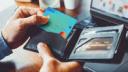 Close-up of a man's hand taking credit card from wallet for business or shopping online.
