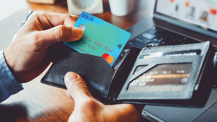 Close-up of a man's hand taking credit card from wallet for business or shopping online.