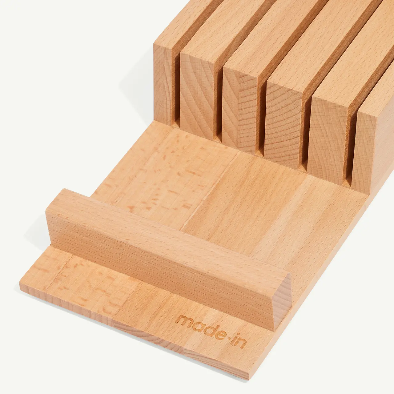 A wooden knife block with multiple slots for knife storage is shown.