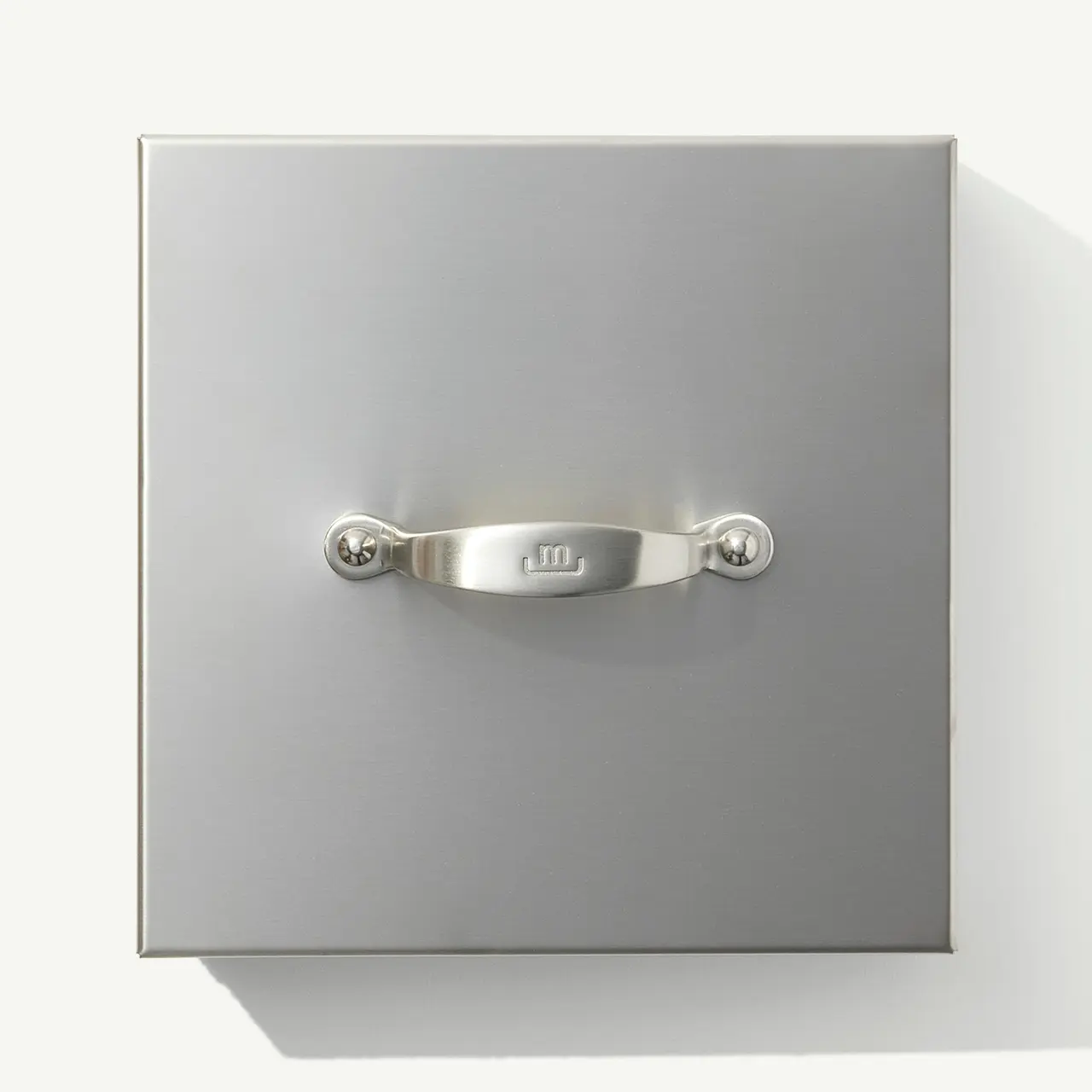 A square-shaped metallic wall switch with a lever handle in the center.